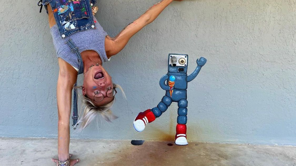 Sally Martin poses with Zambo, a robot she painted from a stain in Castle Hayne. (Courtesy: Sally Martin)